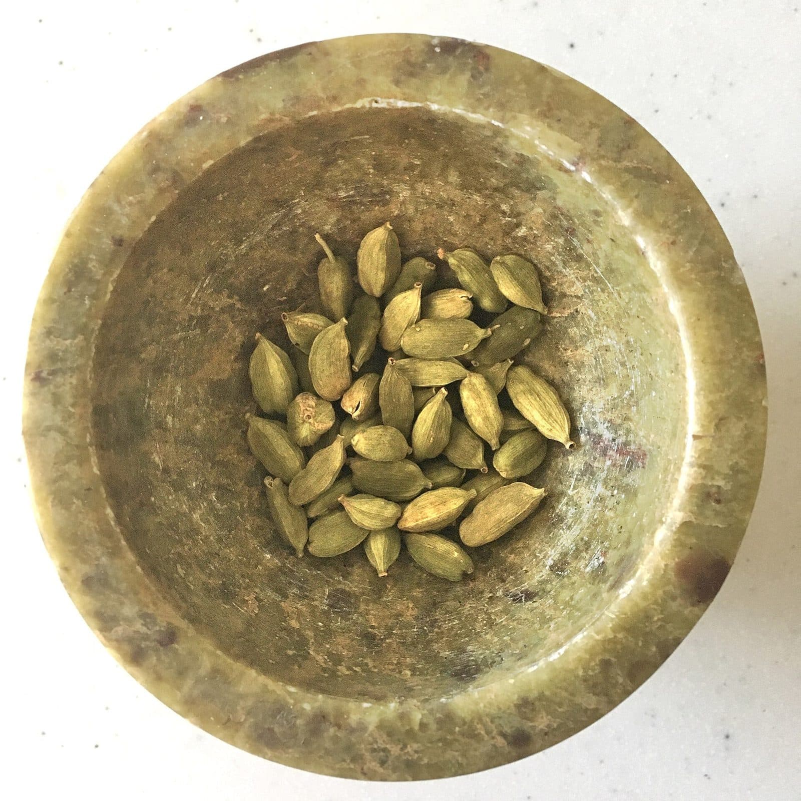 A pile of green cardamom pods.